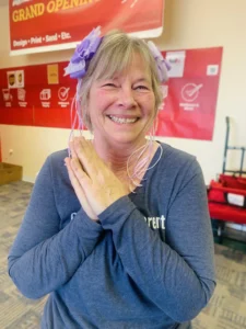 Woman in a PostNet center with a bow in her hair